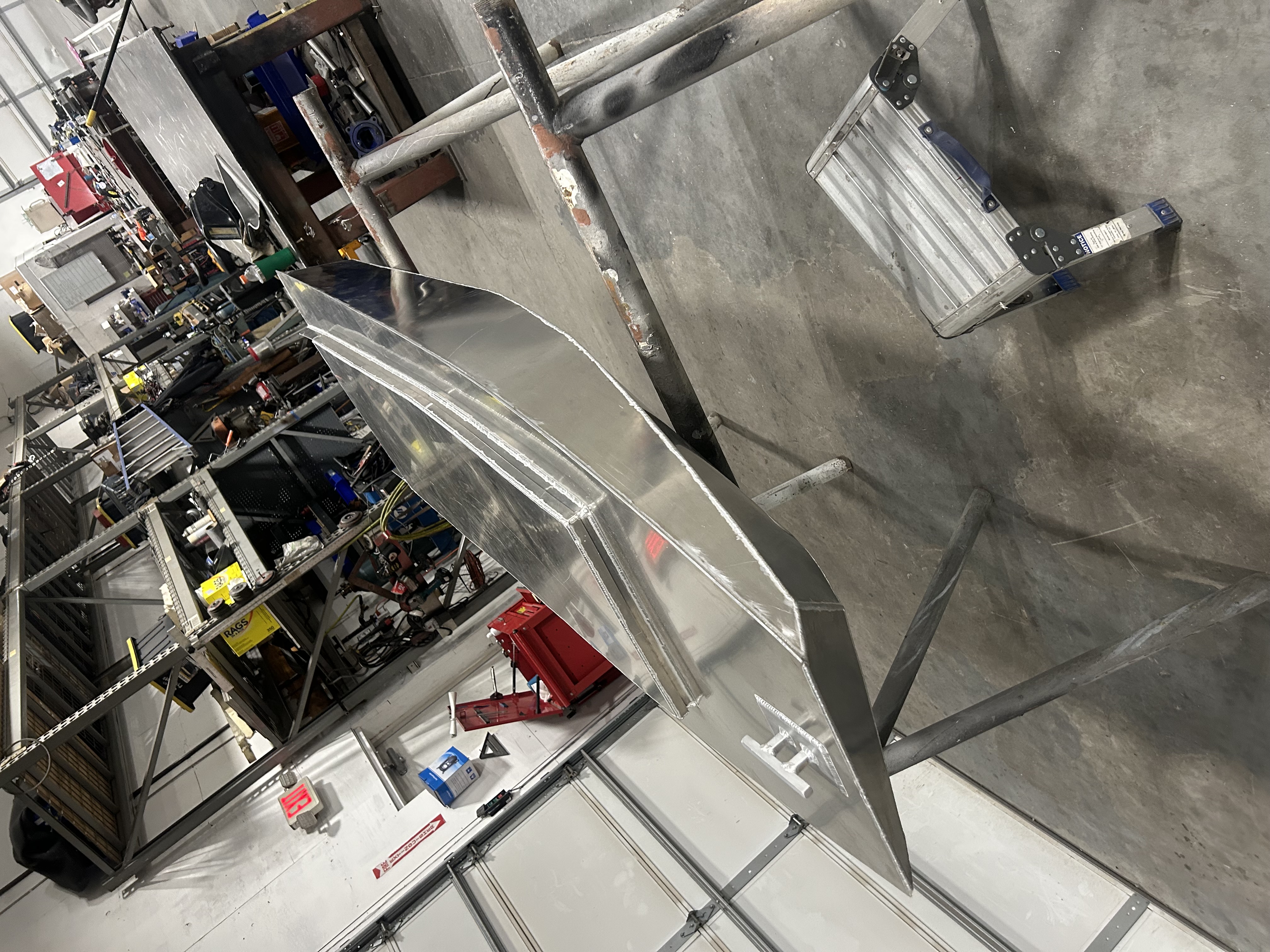 Cut aluminum fabrication parts laid out in the shop