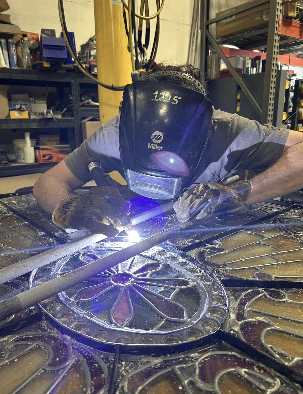 Welding a decorative metal gate panel in the workshop